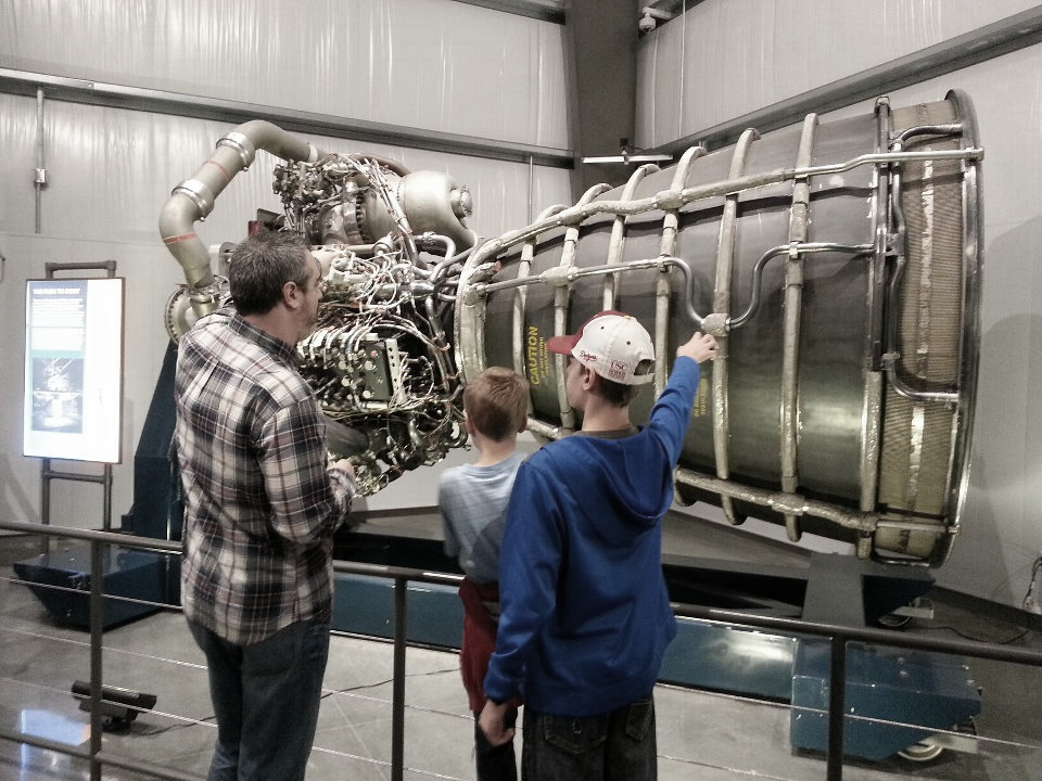 Looking at space shuttle engine with my boys.